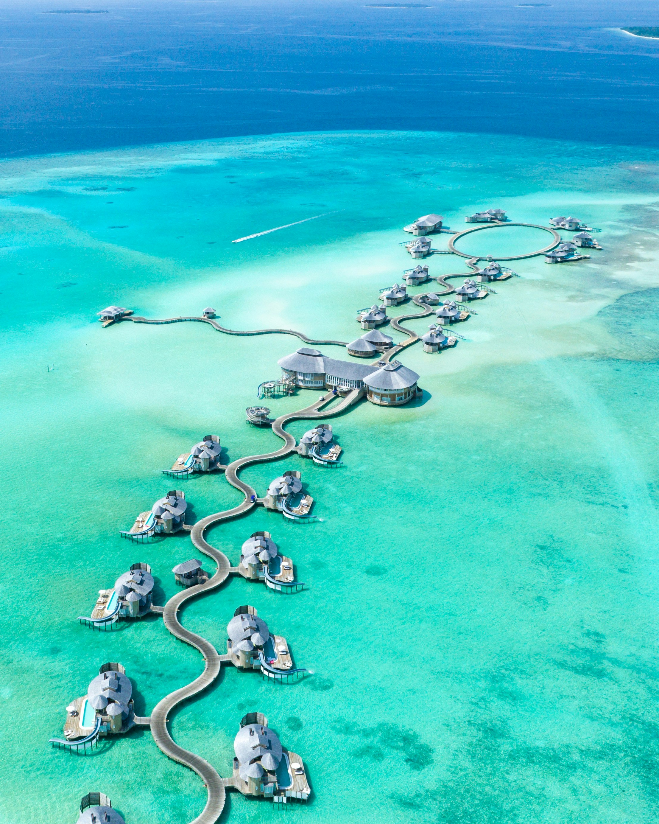 Soneva Jani Maldives luxury overwater villas with glass ceiling, infinity pool and snorkeling in turquoise lagoons